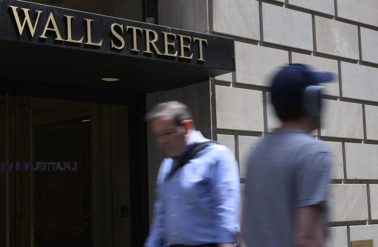 Picture of people walking on Wall Street in lower Manhattan.