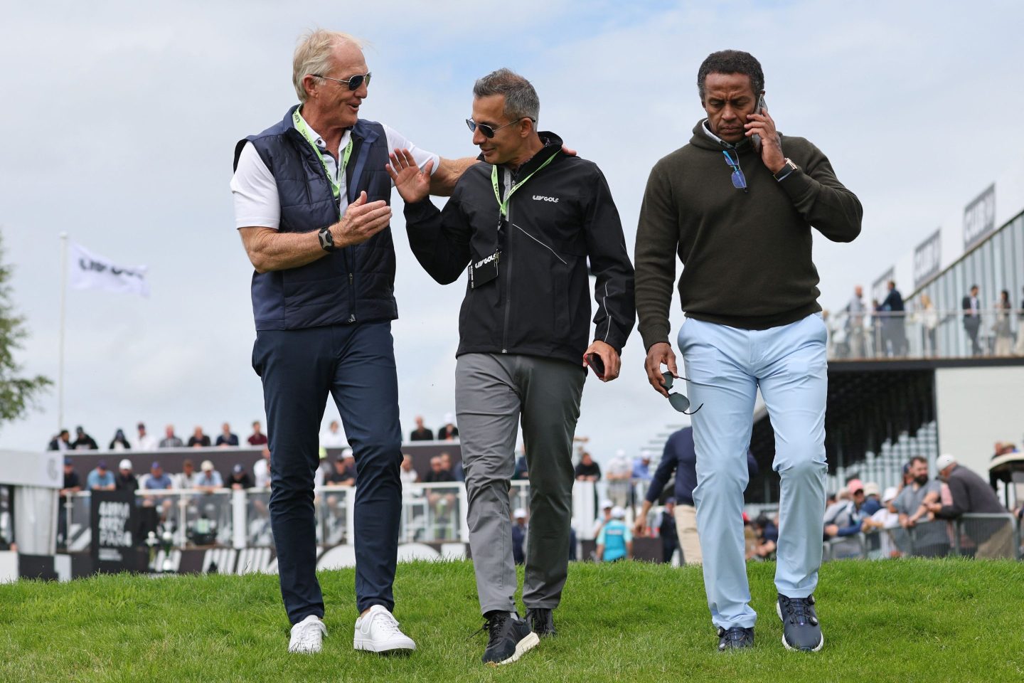 Chief Executive of LIV Golf, Greg Norman (L), Chief Operating Officer of LIV Golf, Atul Khosla (C) and Saudi golf federation Chief Executive, Majed Al Sorour (R) leave the 1st tee on the first day of the LIV Golf Invitational Series event at The Centurion Club in St Albans, north of London, on June 9, 2022.