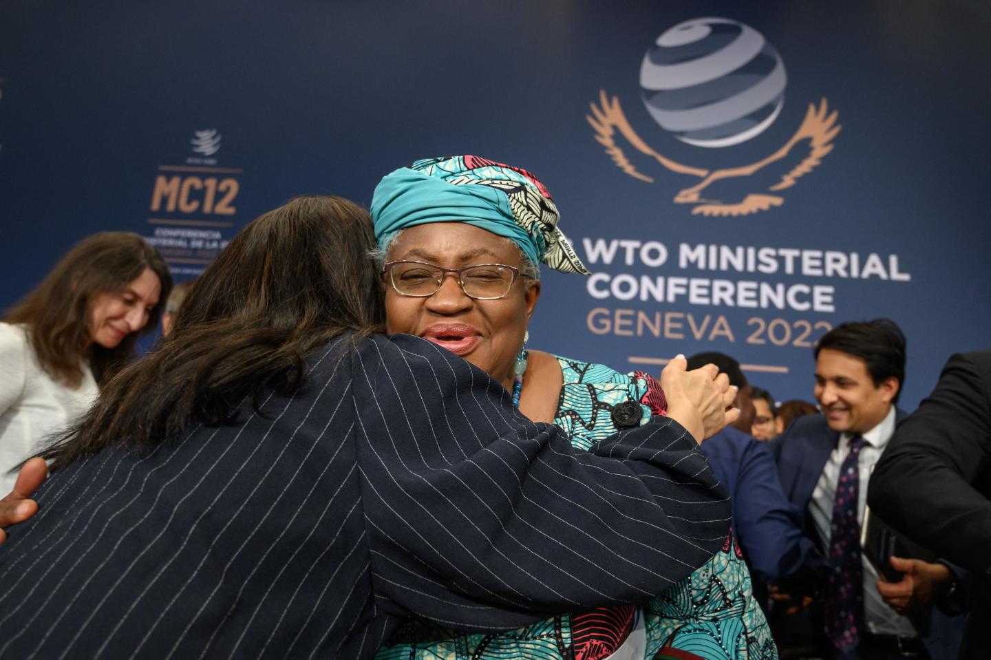 Delegates react with World Trade Organization Director-General Ngozi Okonjo-Iweala (C) after a closing session of a World Trade Organization Ministerial Conference at the WTO headquarters in Geneva on early June 17, 2022.