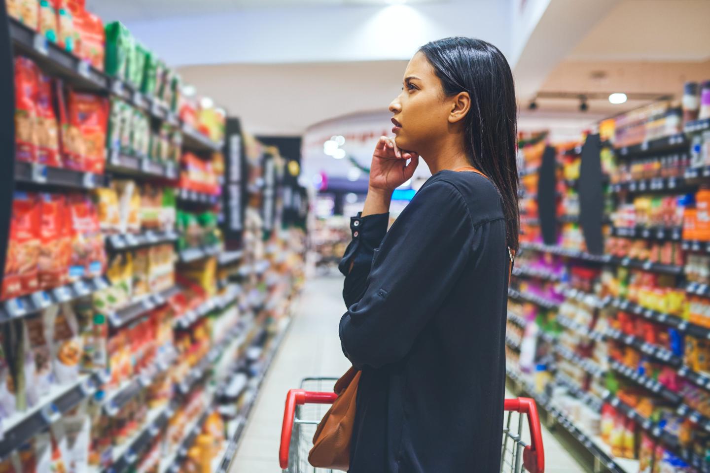 Shot of a young woman shopping in a grocery store