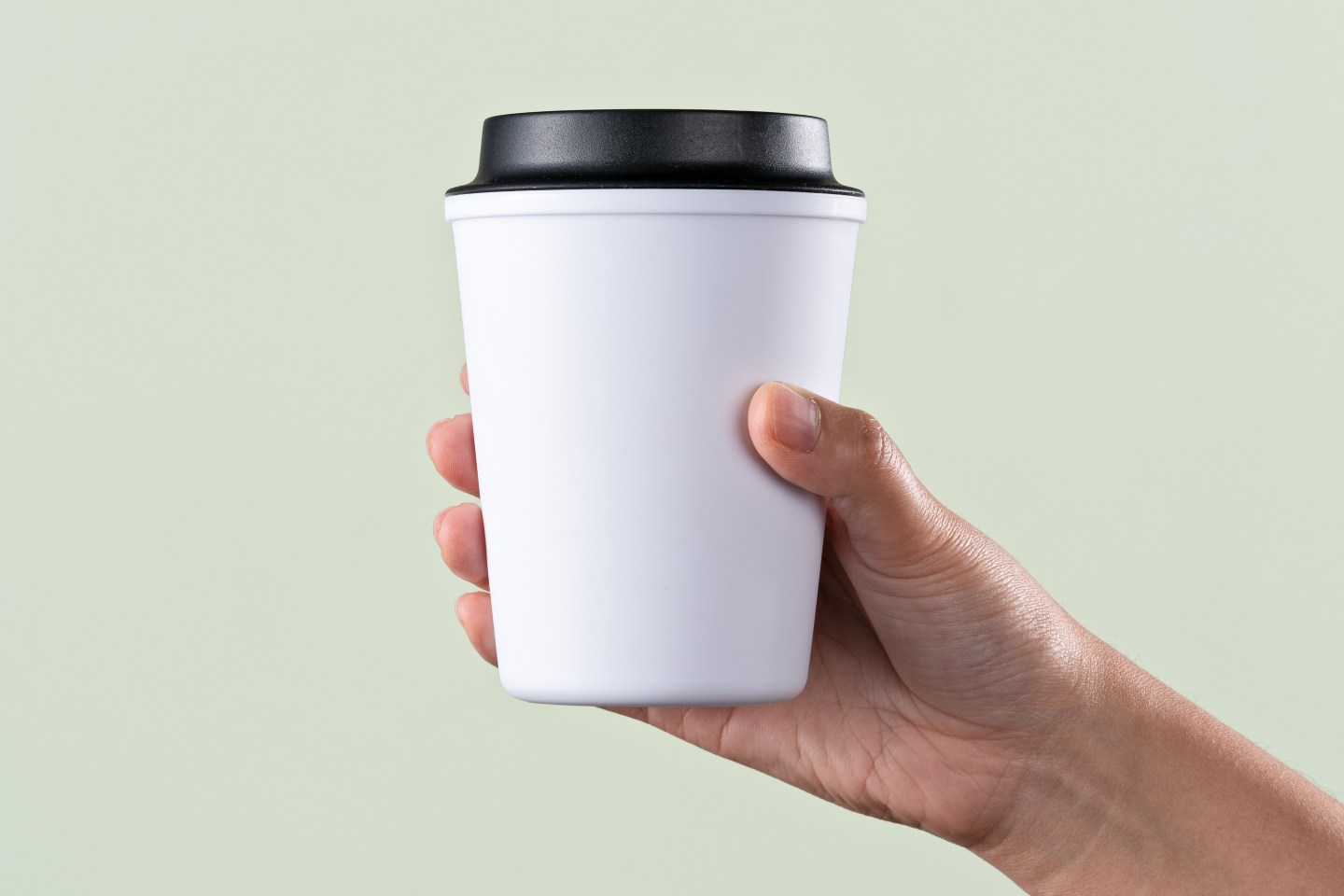 Person holding a cup of coffee