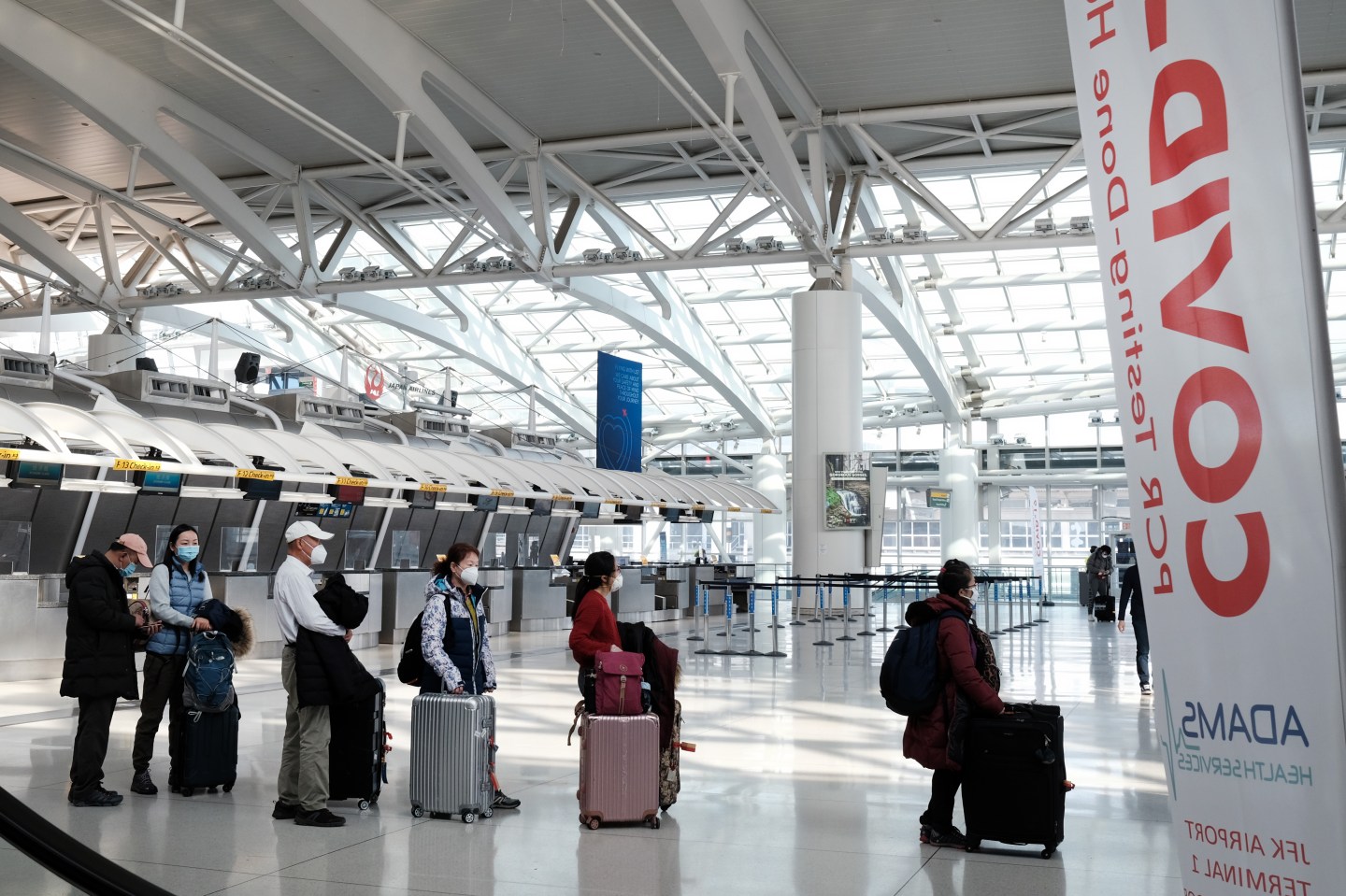 People wait for a flight at an international terminal at John F. Kennedy Airport (JFK) on January 25, 2021, in New York City.