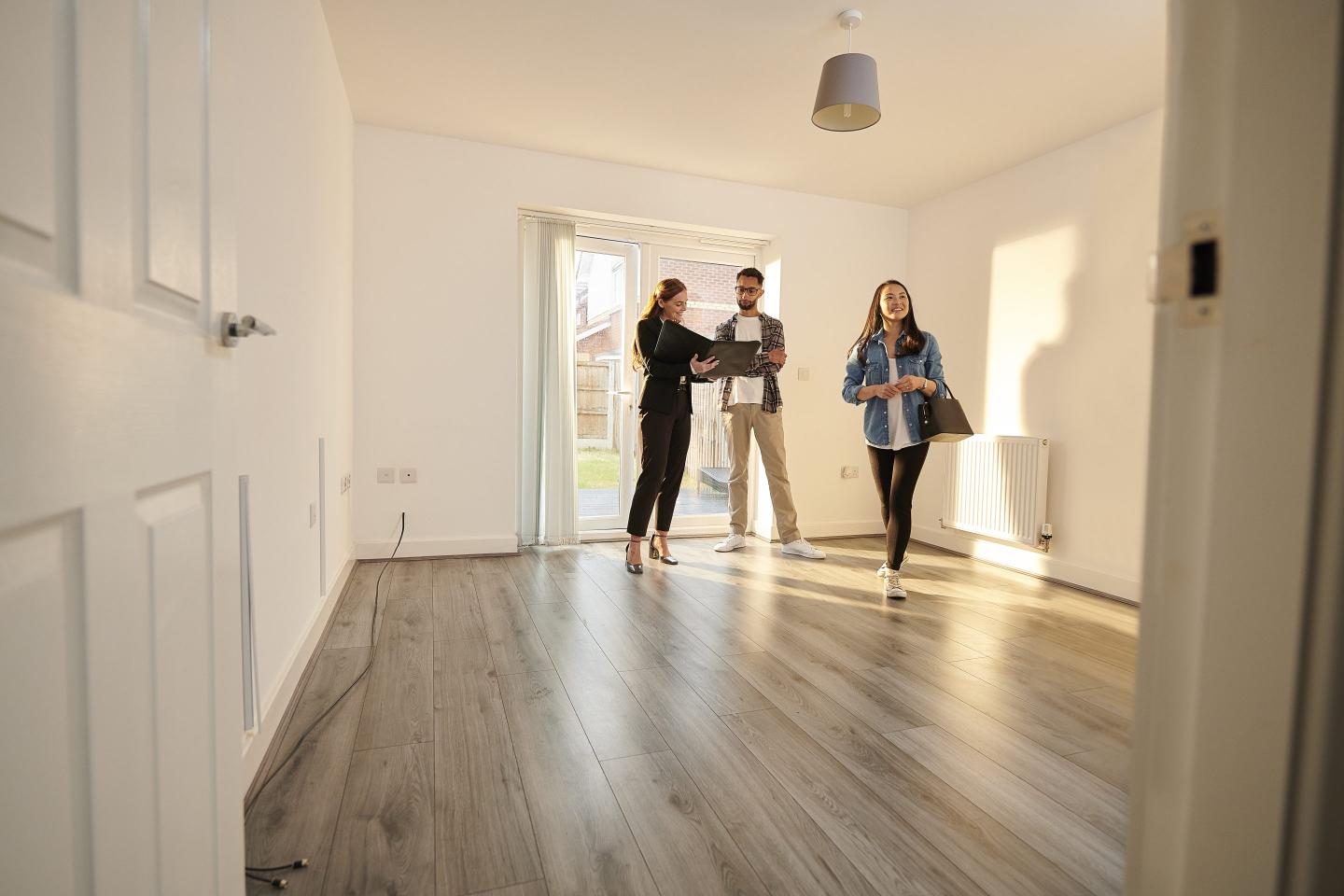 Prospective renters view apartment with real estate agent