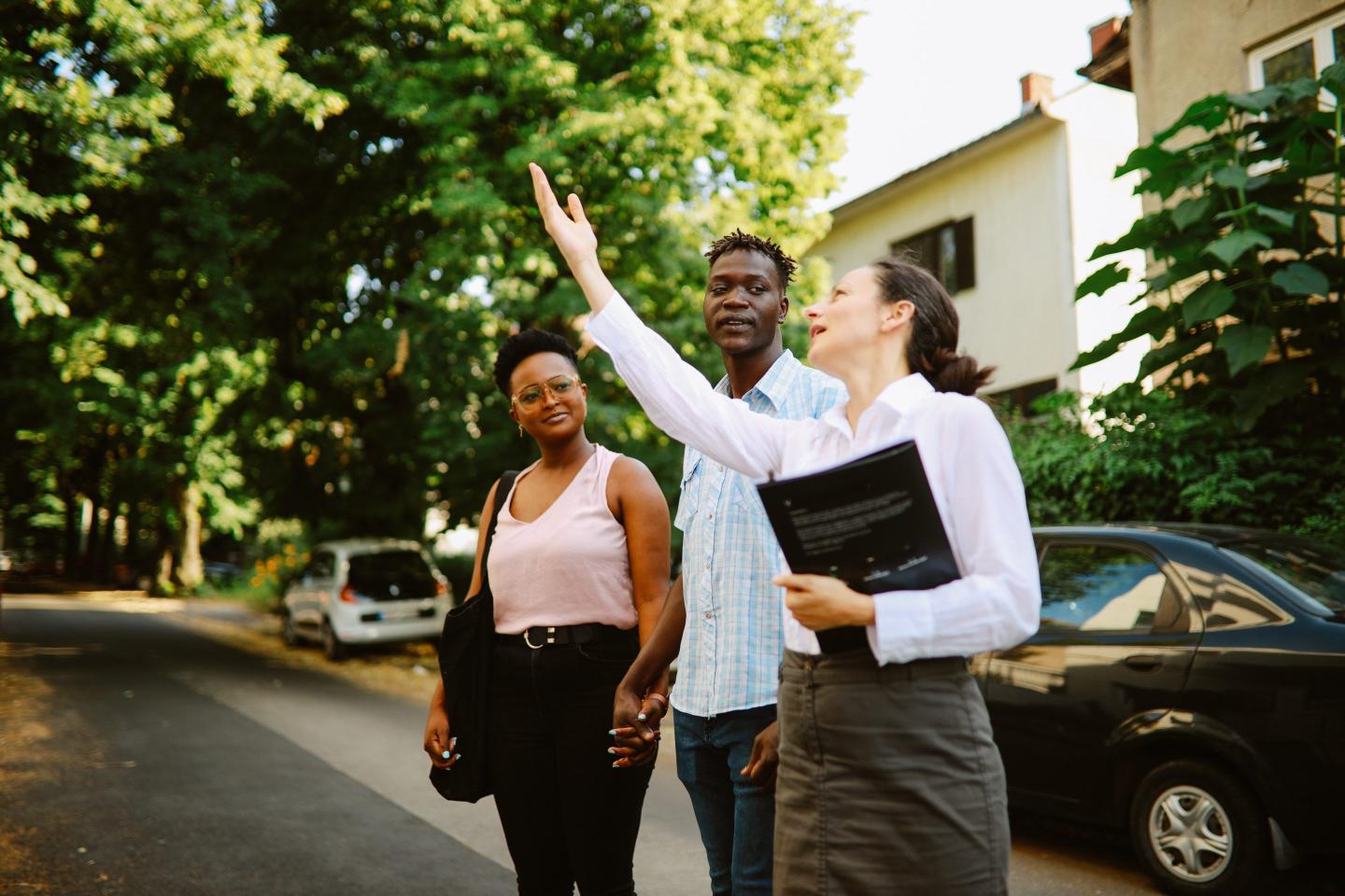 Young couple meeting with the realtor looking for an apartment to buy.