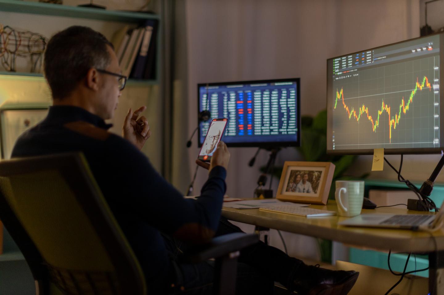 trader looks at screen