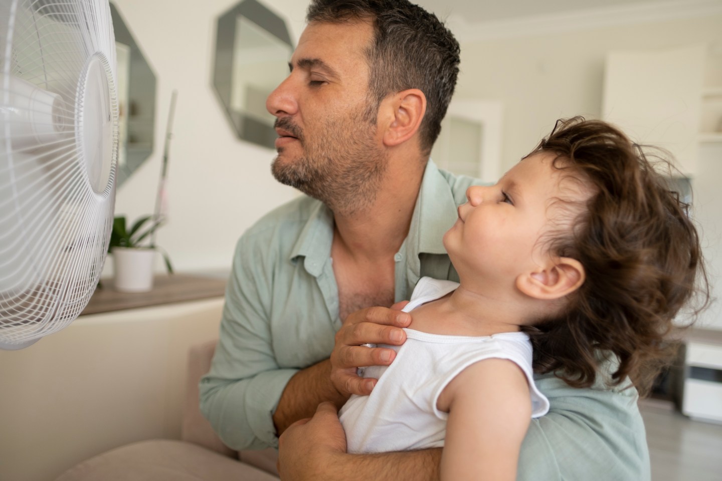 father and child with fan