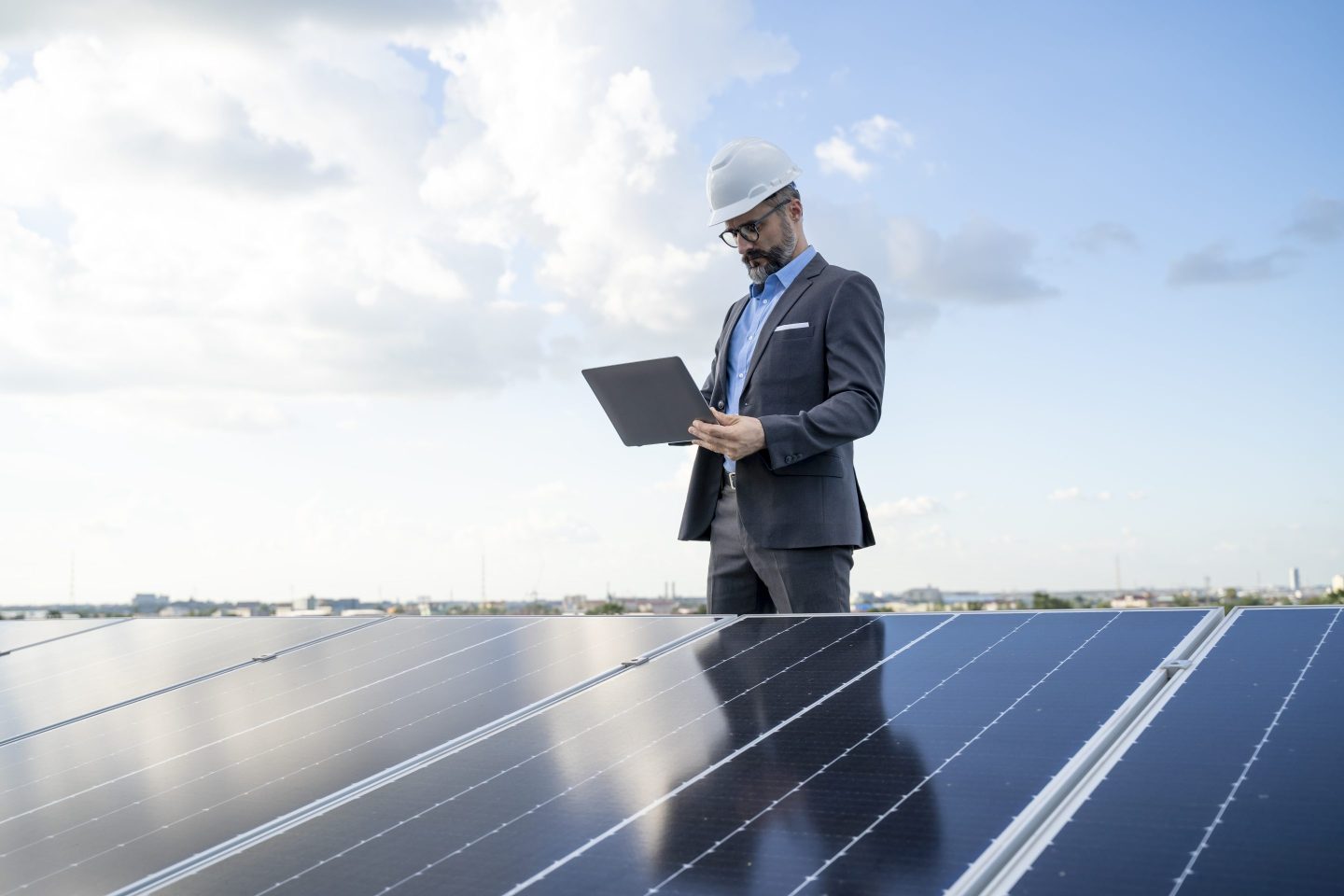An engineer inspects solar panels