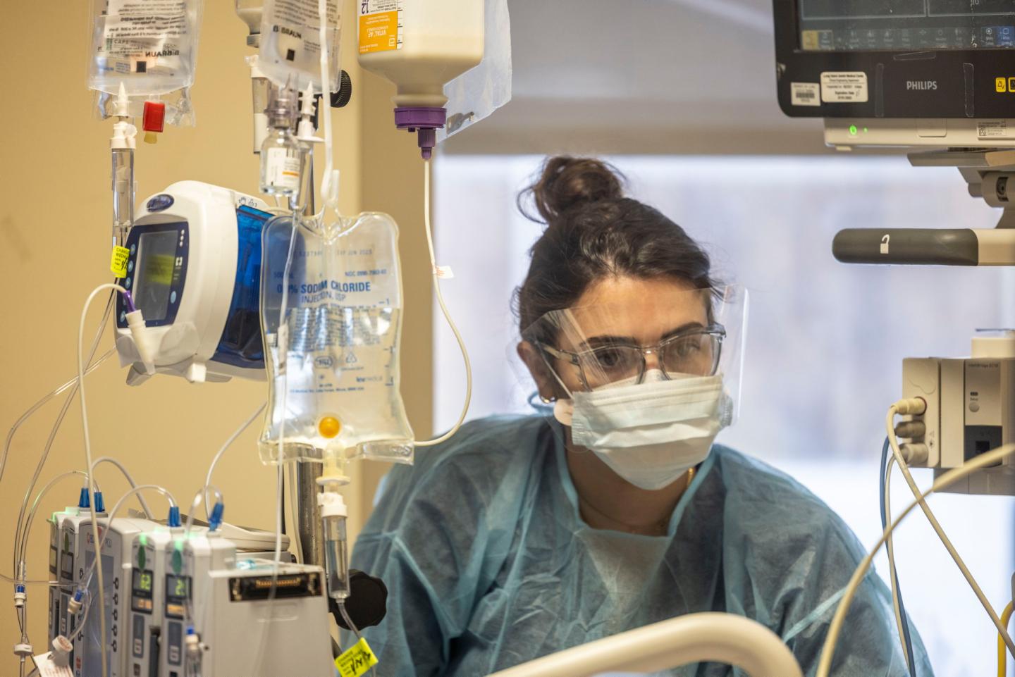 A nurse checks on a patient in intensive care in New Hyde Park, N.Y.