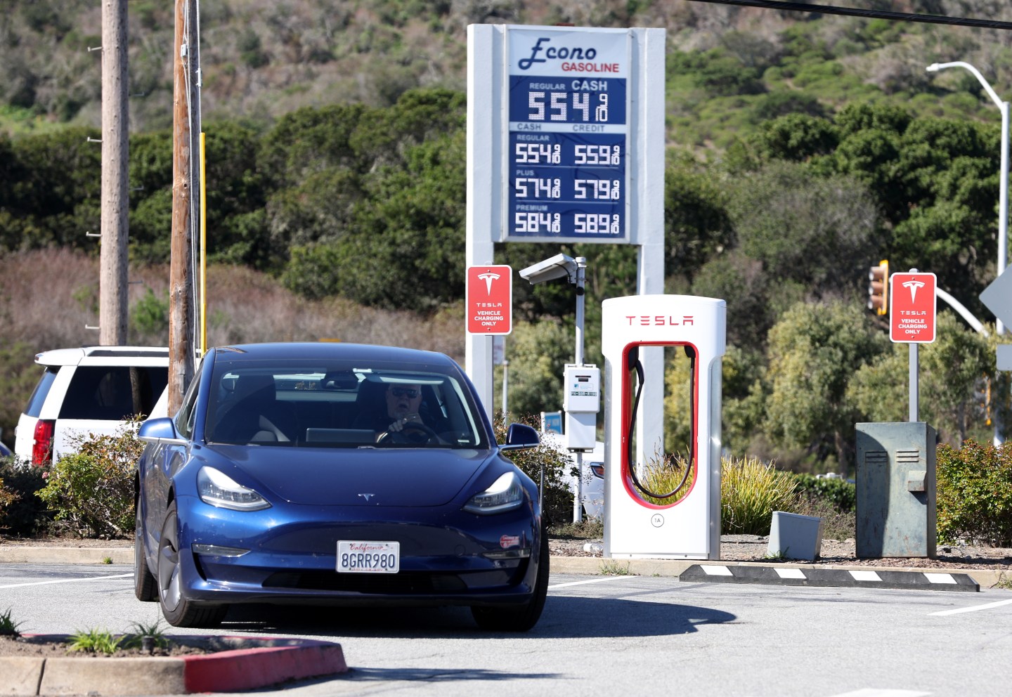 A Tesla leaves a Supercharger after recharging its battery on March 10, 2022 in San Bruno, Calif.