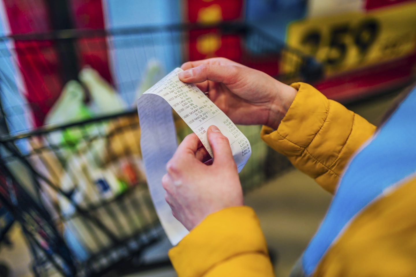 Woman looking at receipt from a supermarket.