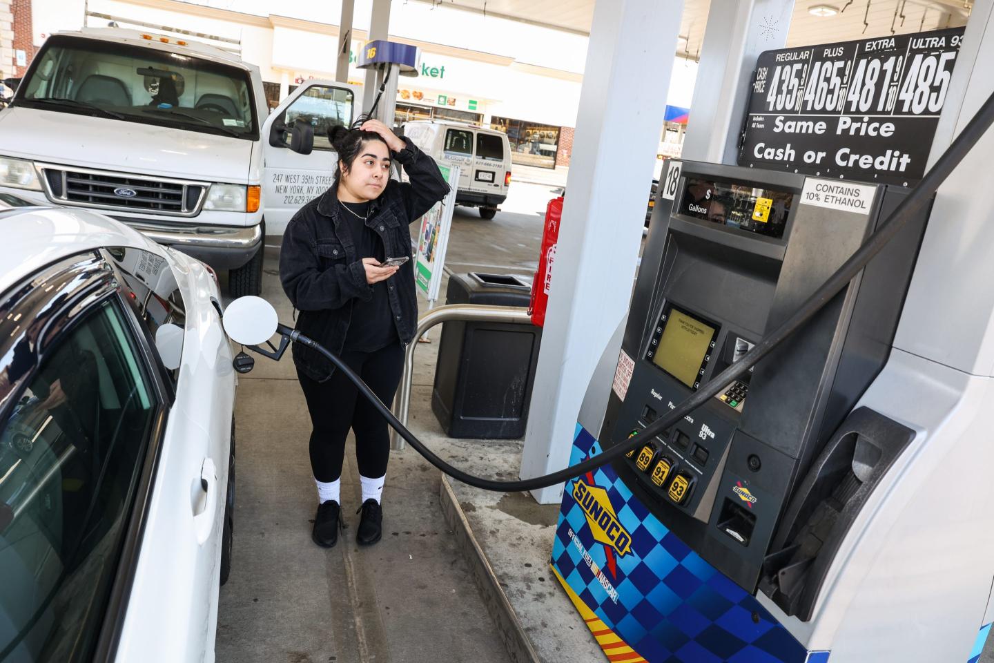 A woman at a gas station