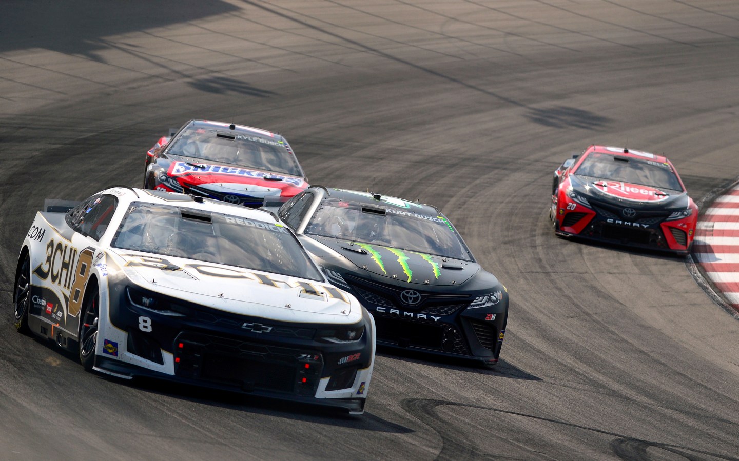 MADISON, ILLINOIS - JUNE 05: Tyler Reddick, driver of the #8 3CHI Chevrolet, Kurt Busch, driver of the #45 Monster Energy Toyota, and Christopher Bell, driver of the #20 Rheem Toyota, race during the NASCAR Cup Series Enjoy Illinois 300 at WWT Raceway on June 05, 2022 in Madison, Illinois.