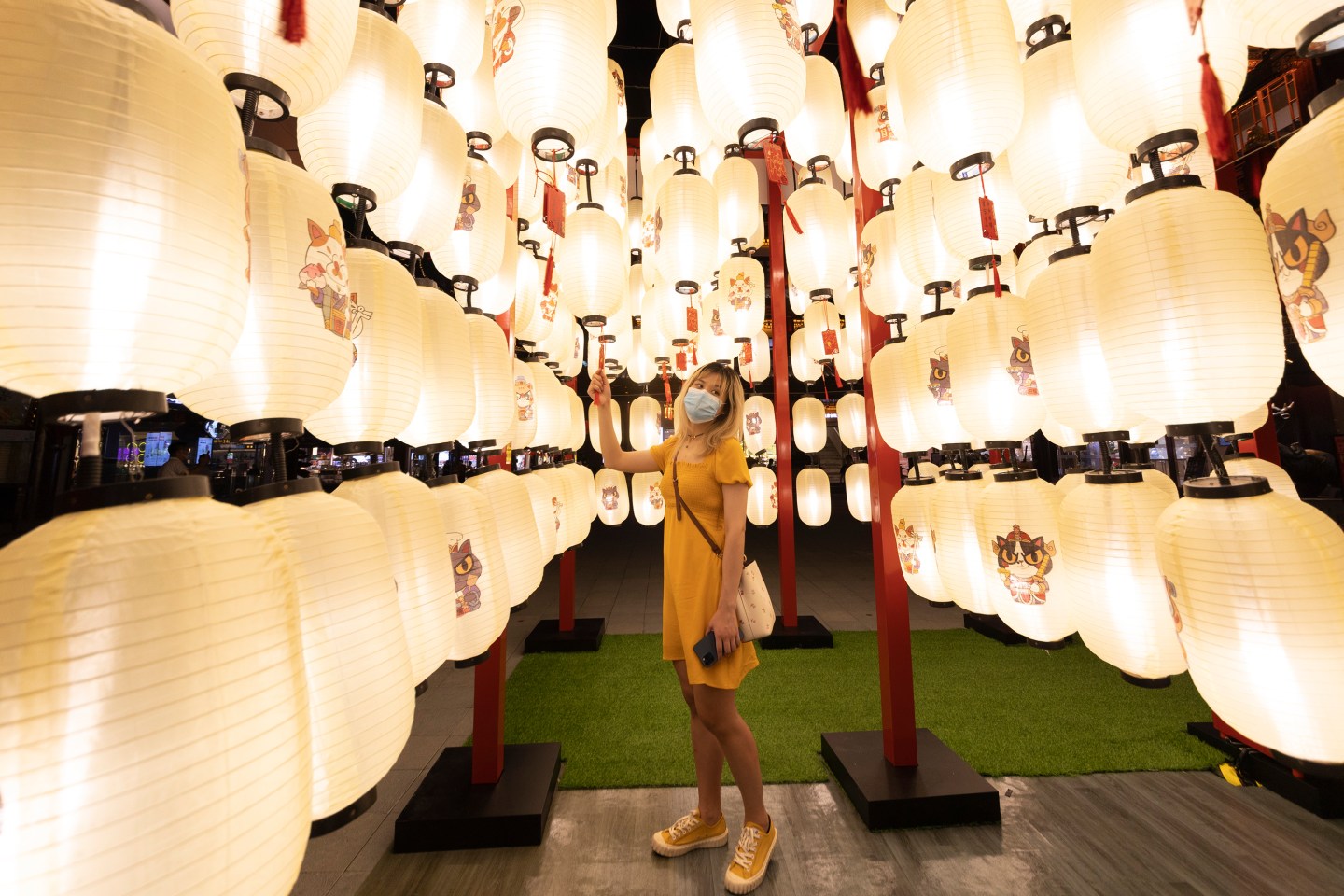 A girl with protective mask poses for photo at Yu Garden malls on June 25 in Shanghai, China.