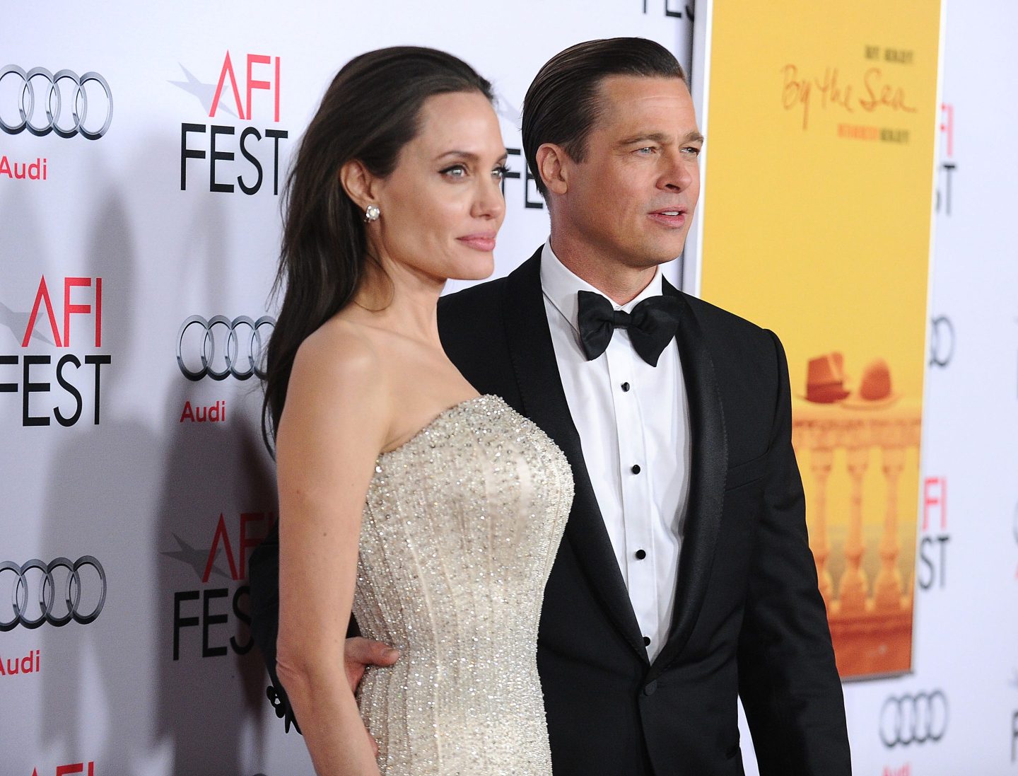 Angelina Jolie and Brad Pitt pose for the cameras at the permiere of "By the Sea"