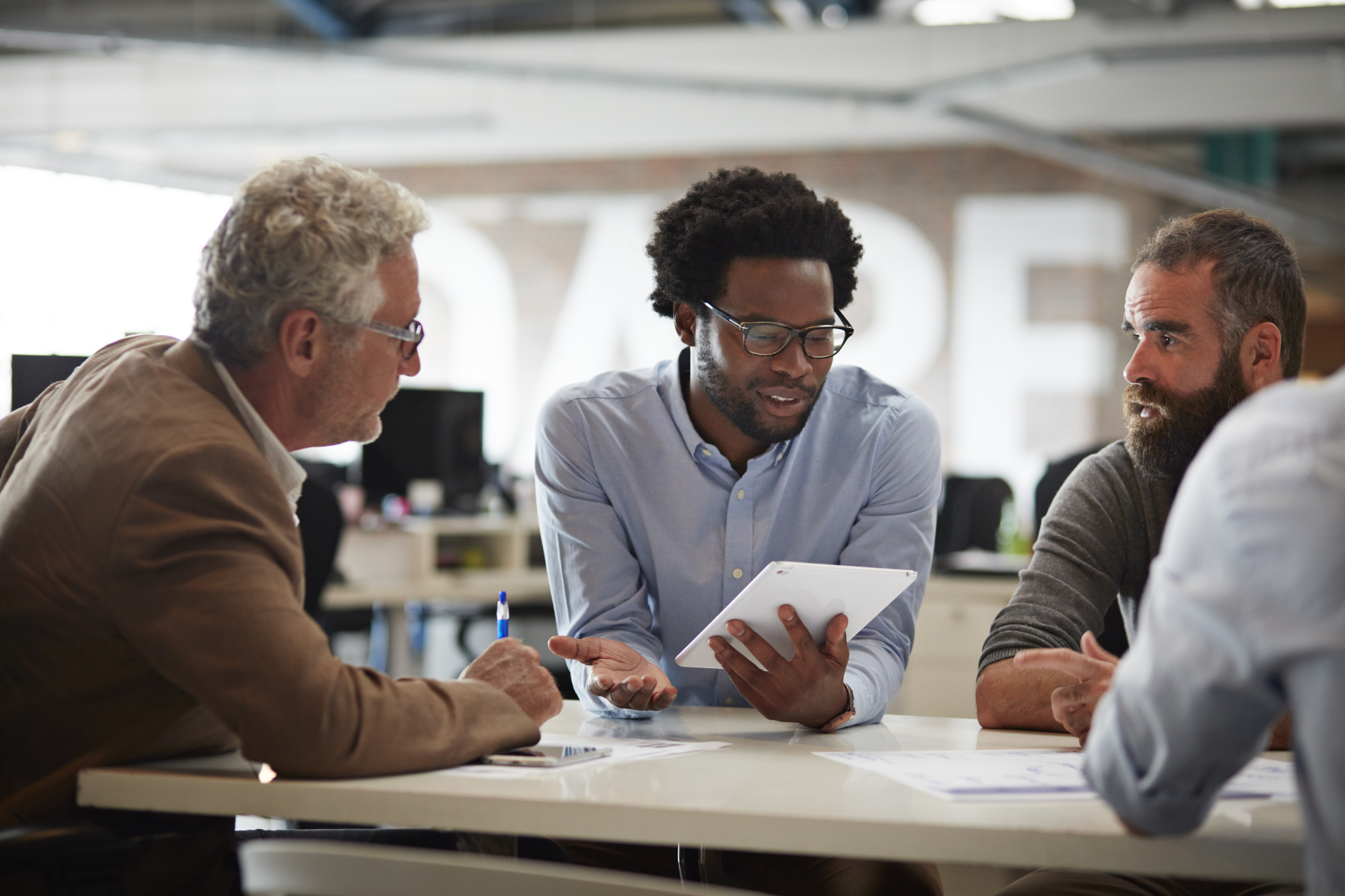 A Black worker with white colleagues