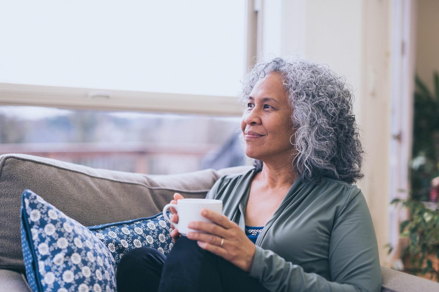 Retiree sits drinking coffee in the morning