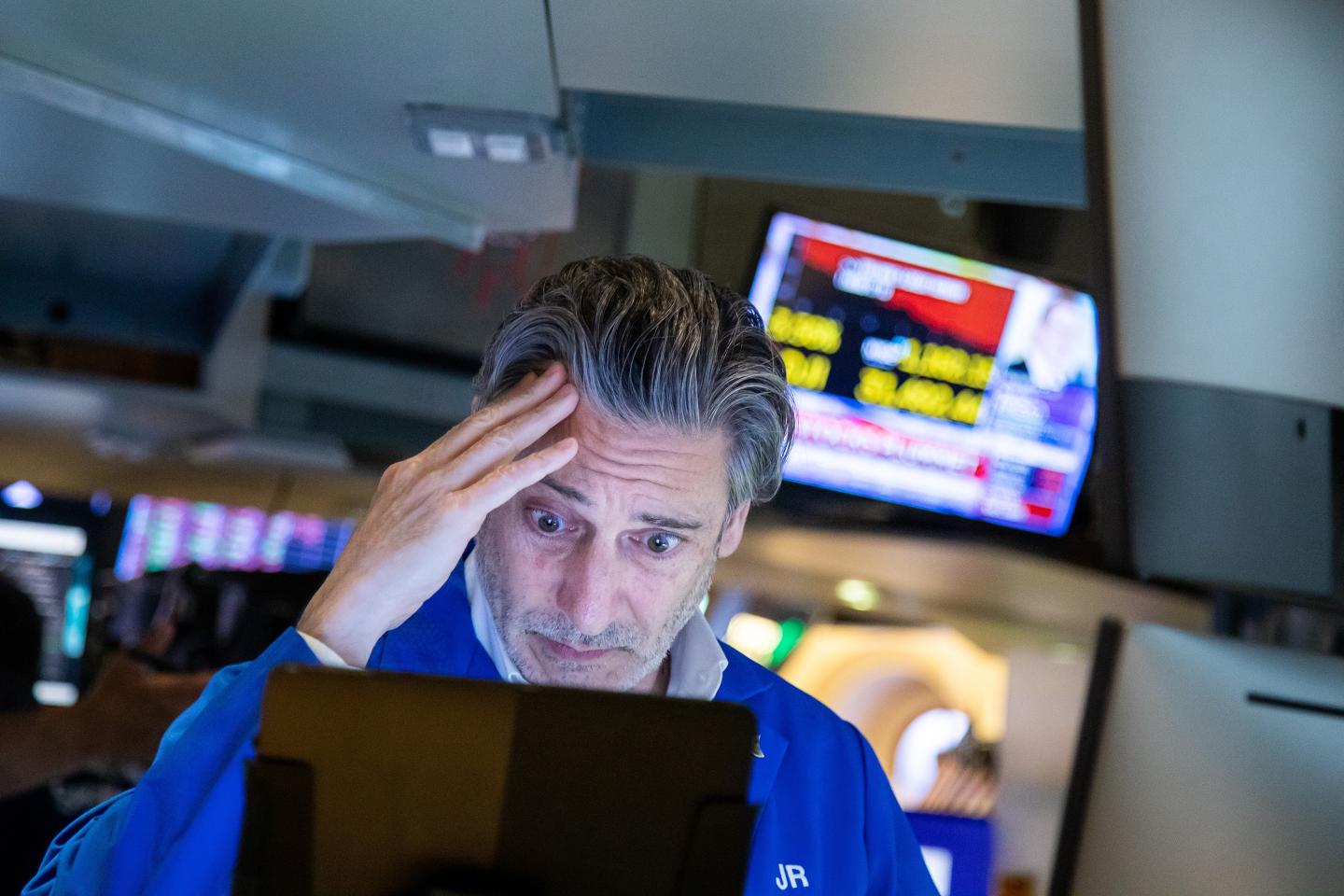 A trader looks concerned at the New York Stock Exchange NYSE>