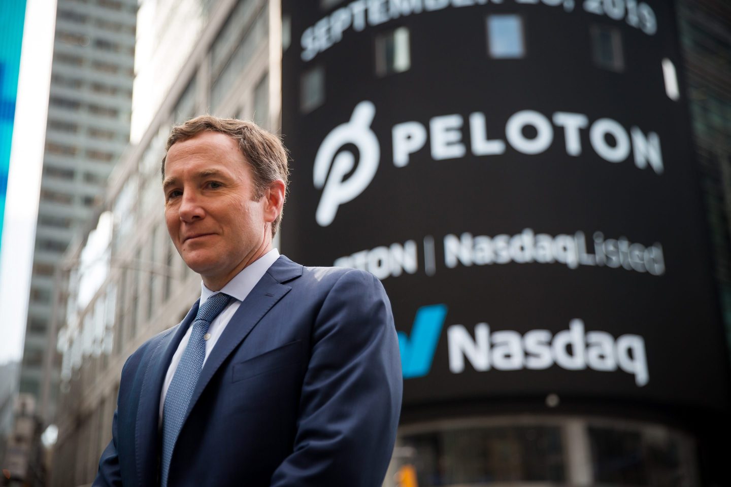 John Foley, co-founder and CEO of Peloton, stands outside the Nasdaq.