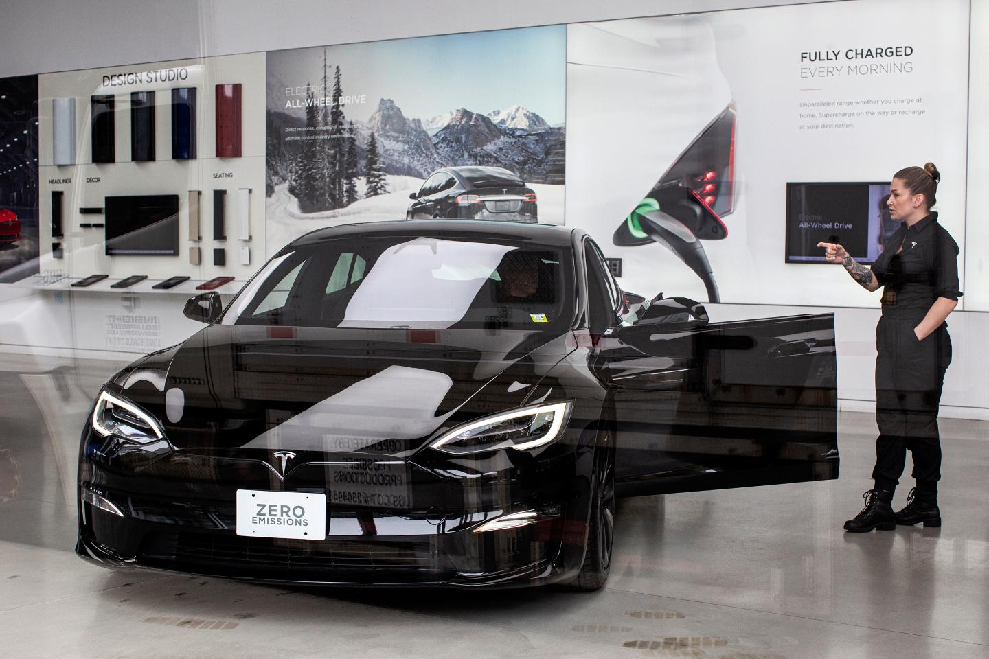Tesla employee talks to a customer inside Tesla's showroom in New York City.