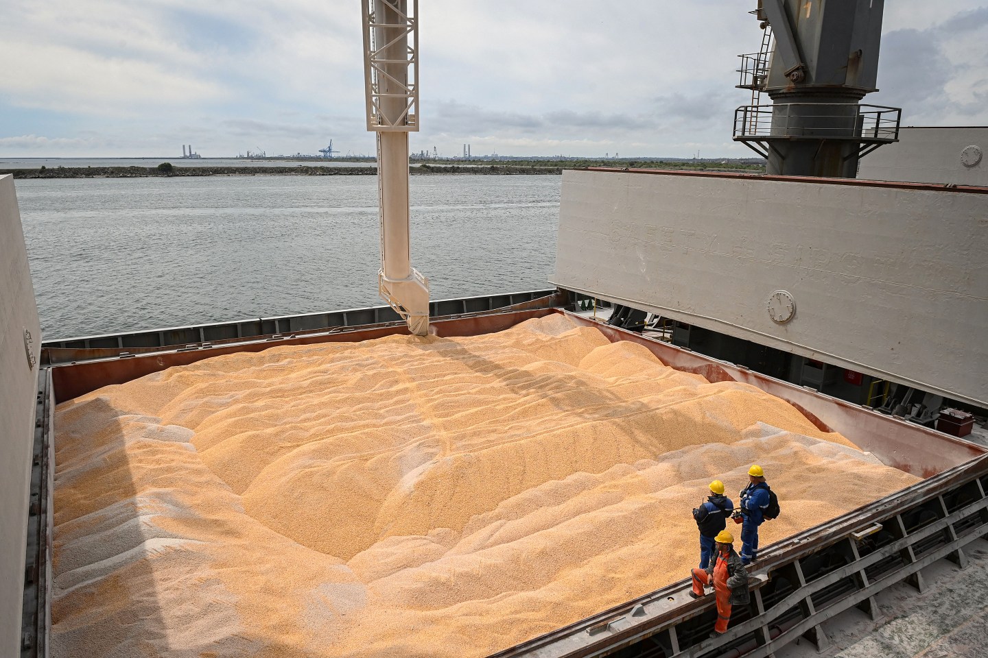 Workers assist the loading of corn on to a ship at Pier 80 in the Black Sea port of Constanta.