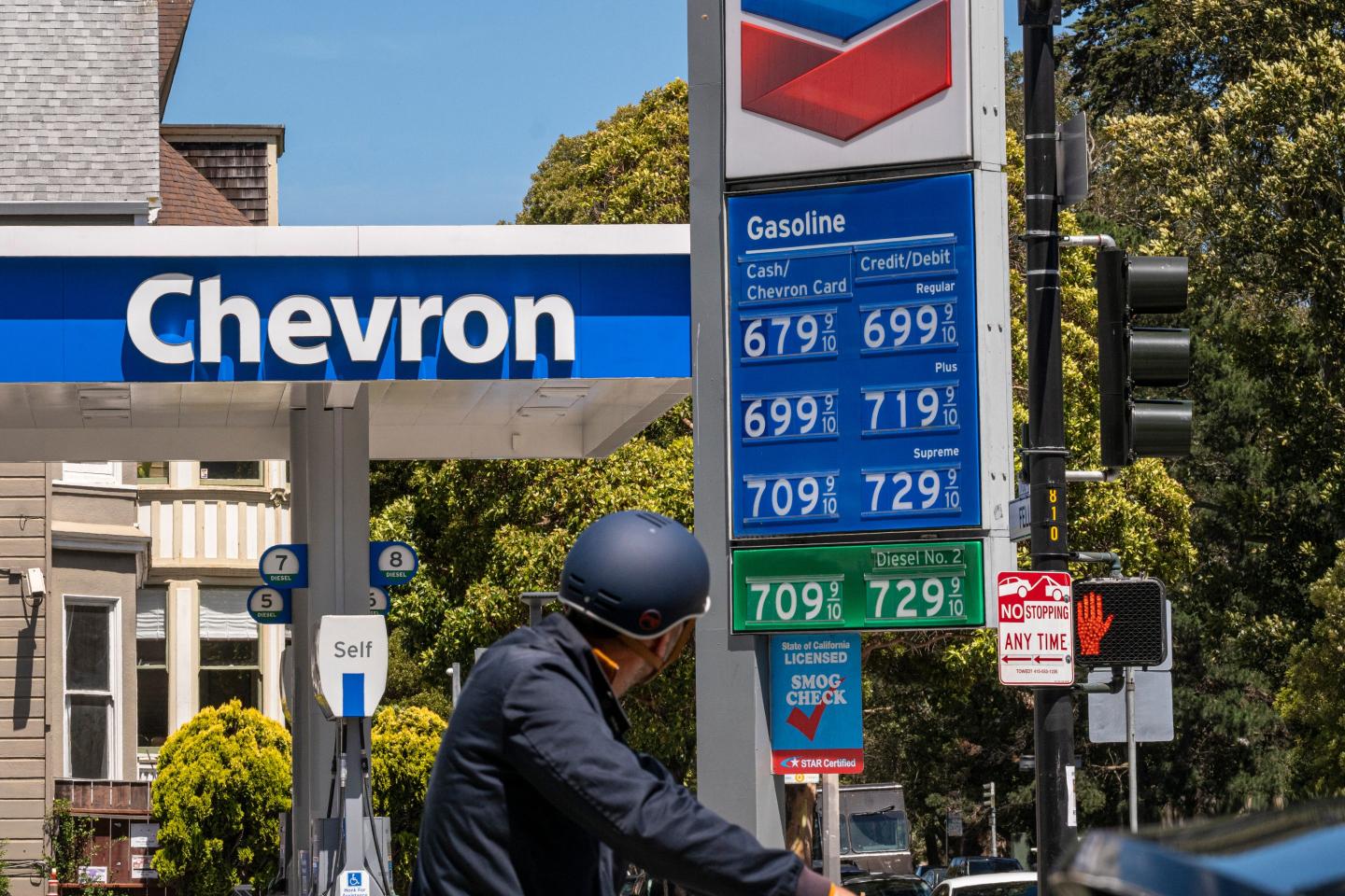 A man looks at the gas prices at a Chevron station.