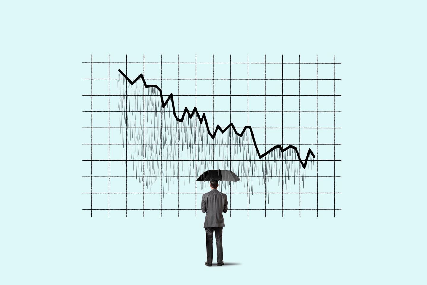 A man stands in front of a downward pointing graph with an umbrella.