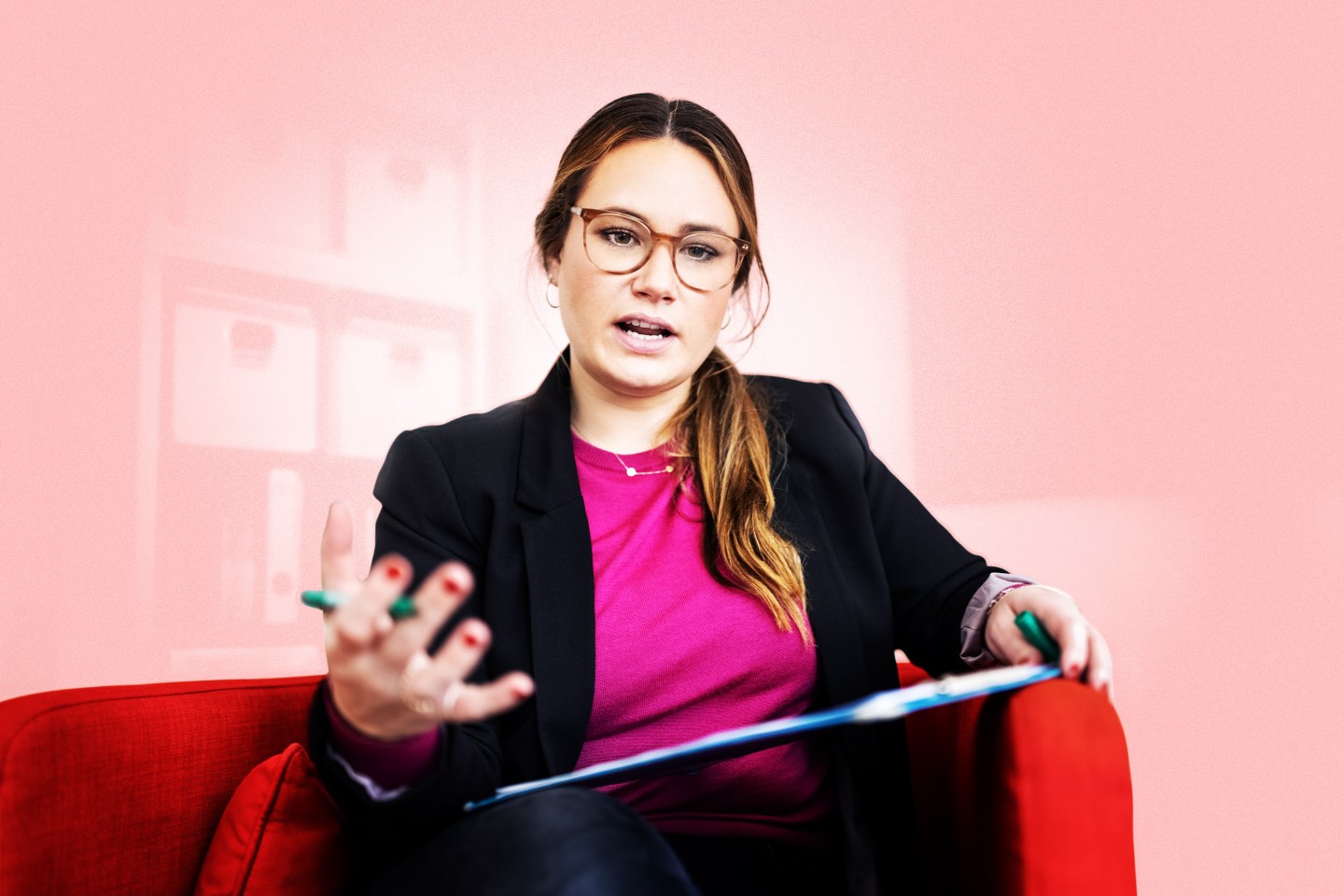 woman sitting in a chair talking to a laptop
