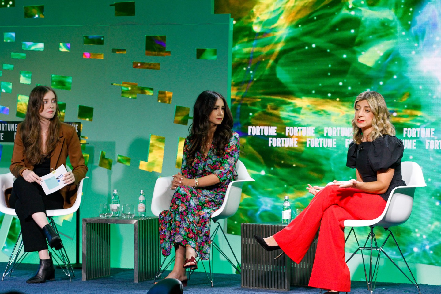 Moderator Emma Hinchliffe sitting with Lux Capital partner Deena Shakir, center, and Tia Clinic CEO Carolyn Witte on the Brainstorm Tech stage