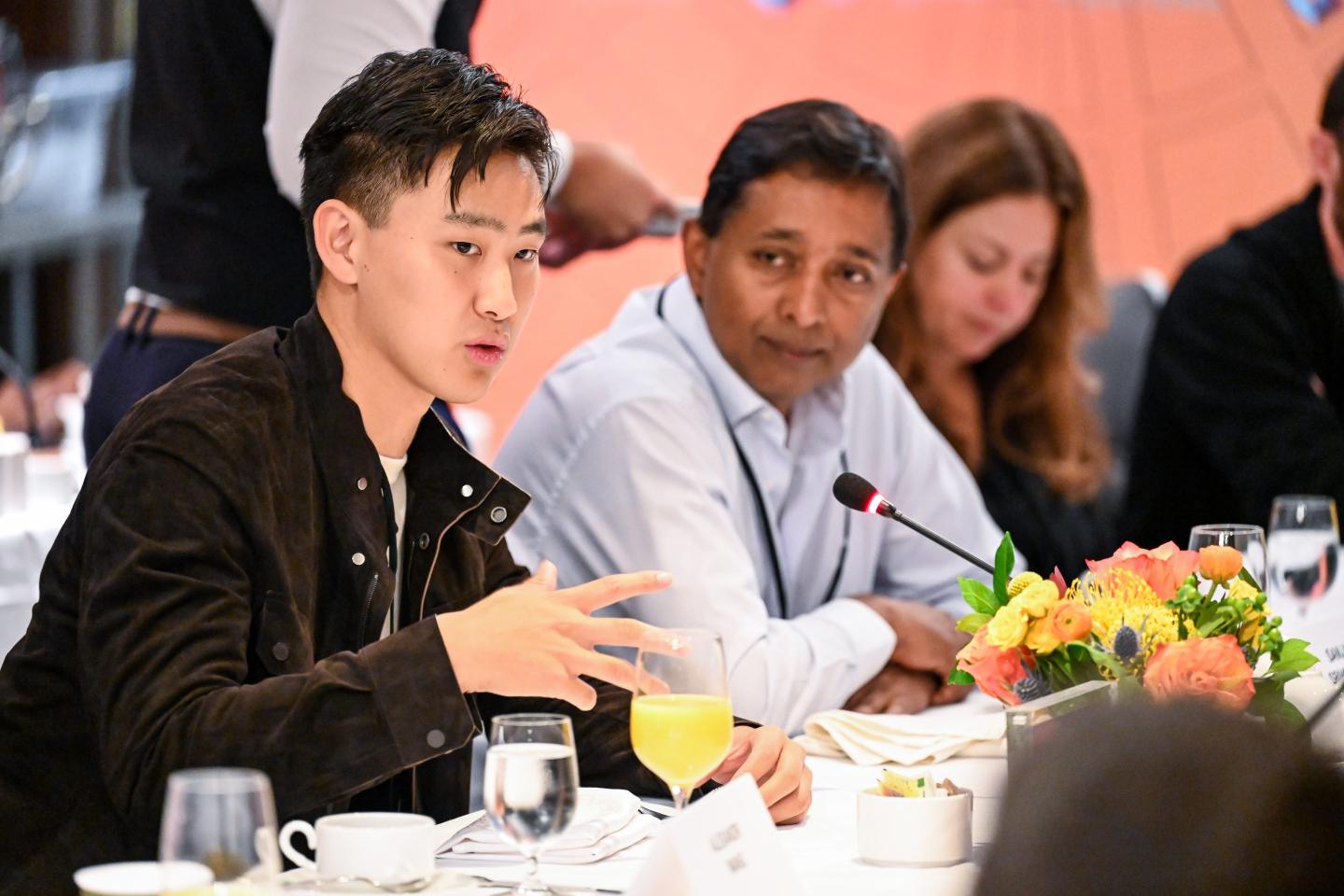 (L-R) Alexandr Wang, CEO of Scale AI, and Sanjay Srivastava, chief digital strategist of Genpact, speak at a table at Fortune's Brainstorm Tech conference in Aspen, Colo.