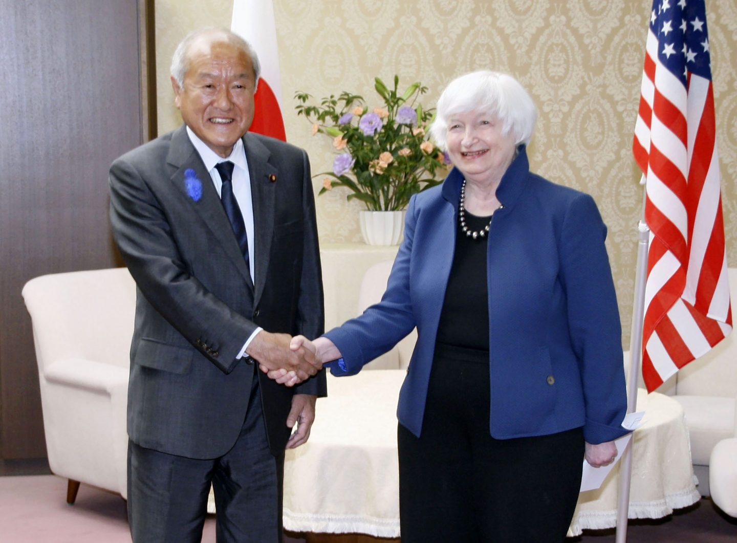 U.S. Treasury Secretary Janet Yellen, right, and Japan's Finance Minister Shunichi Suzuki shake hands during their meeting at the finance ministry in Tokyo on July 12, 2022.