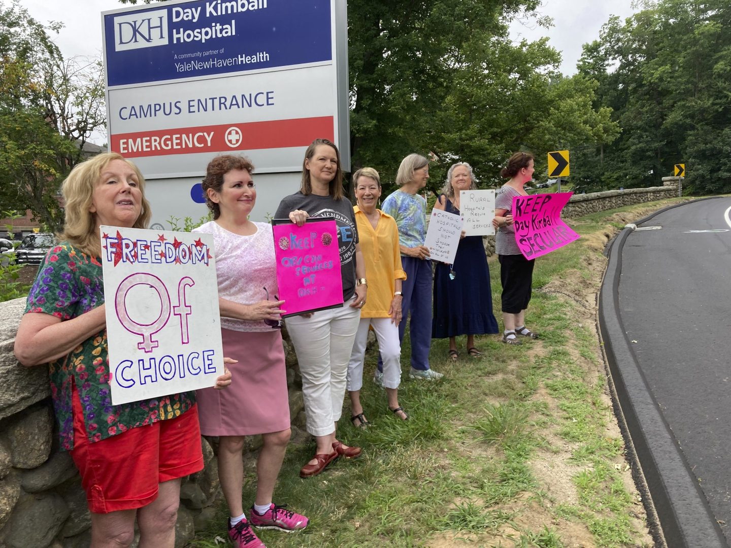 Residents from various communities in mostly rural northeastern Connecticut stage a protest outside Day Kimball Hospital on July 18 in Putnam, Conn. The protesters are concerned with Day Kimball Healthcare's plans to affiliate with Covenant Healthcare, a Catholic health system that abides by directives set by the U.S. Conference of Catholic Bishops.