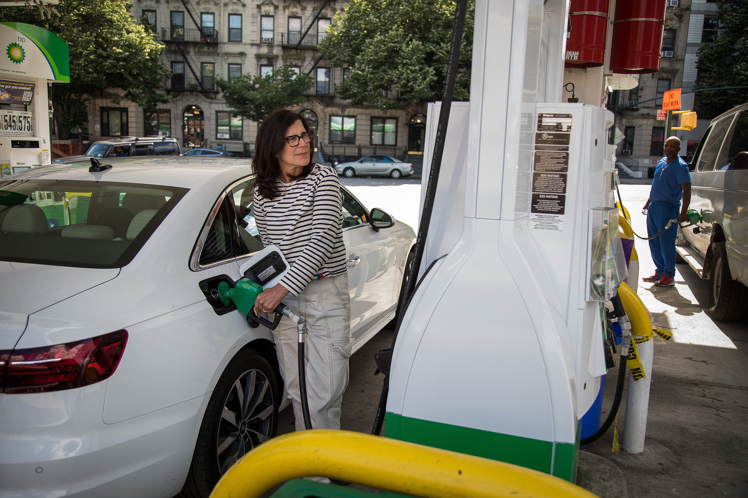 People fuel vehicles at a gas station in Brooklyn.