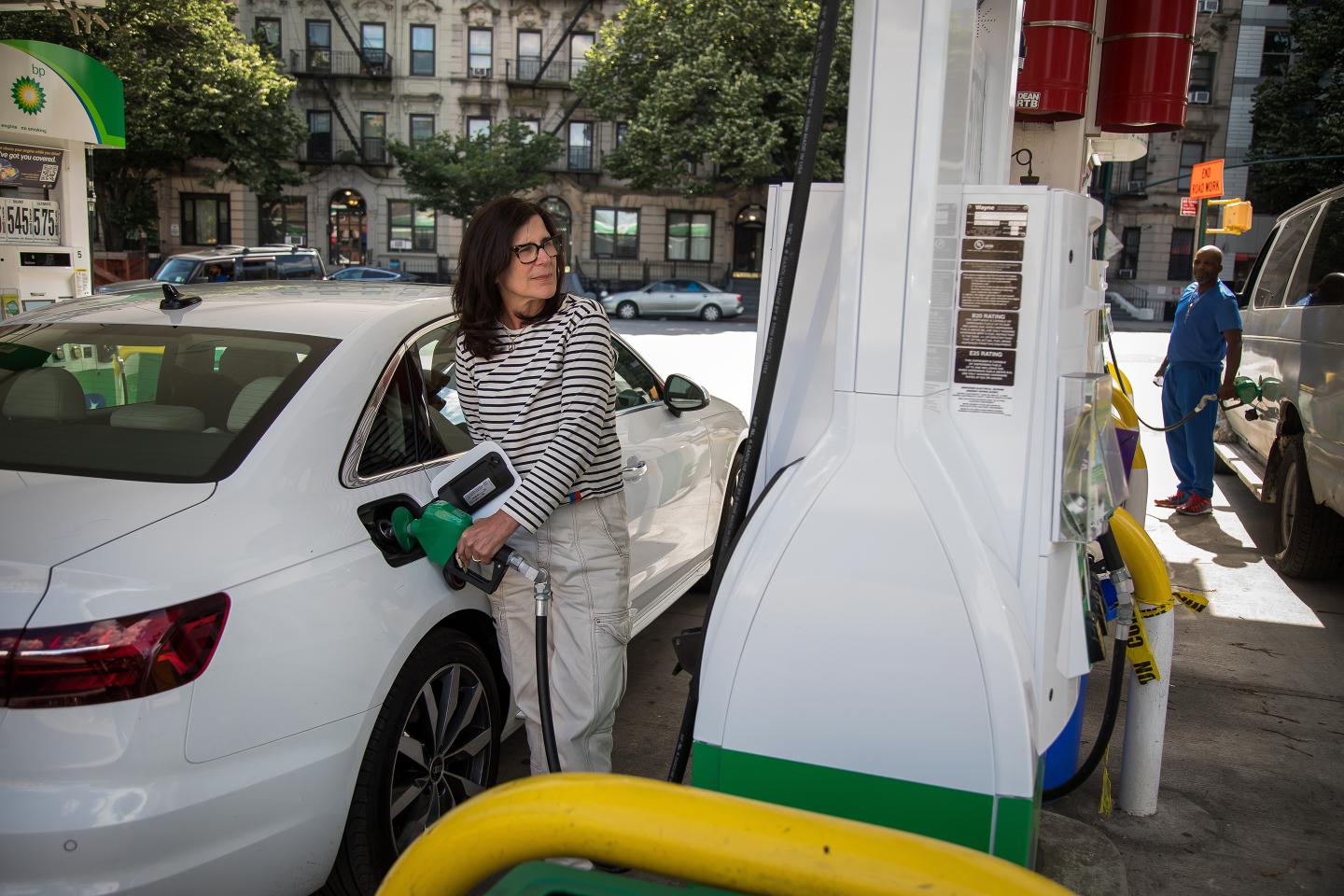 People fuel vehicles at a gas station in Brooklyn.