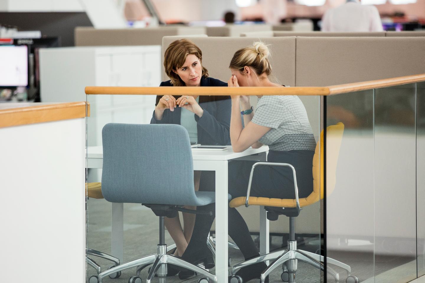 Two female colleagues having a meeting, one of them is crying upset.