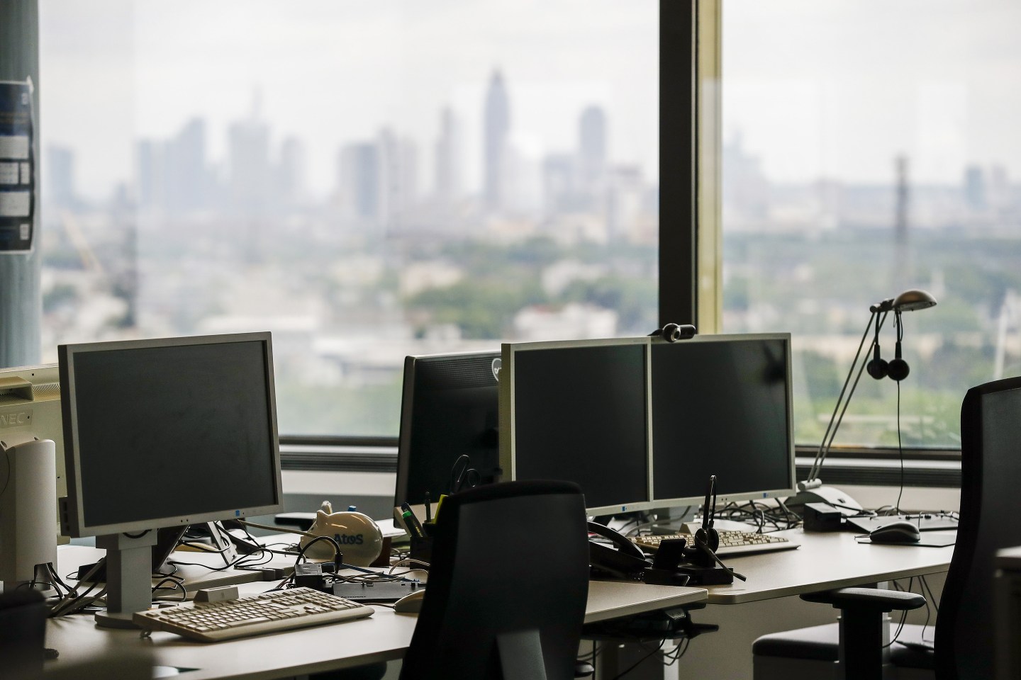 Empty desks near window in office.