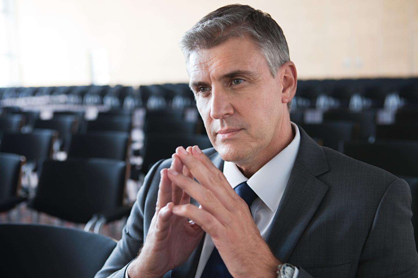 A businessman sits in a conference room