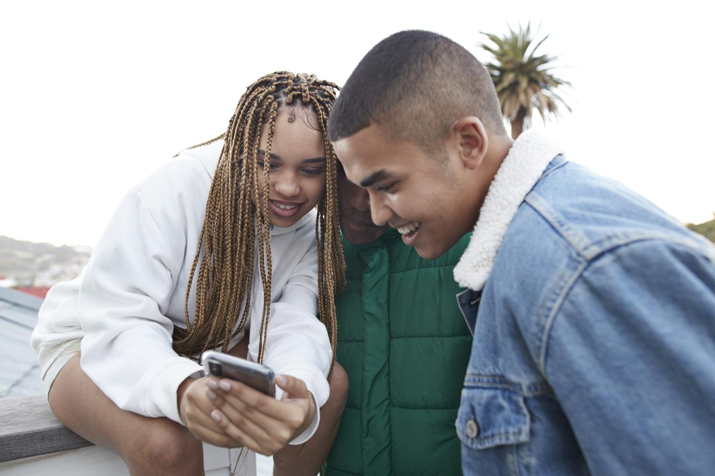 Teens looking at a phone