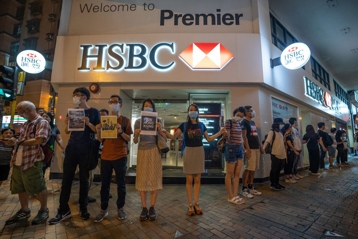 Photo of Hong Kong pro-democracy protestors forming a human chain in front of an HSBC bank branch in Hong Kong on August 23, 2019.