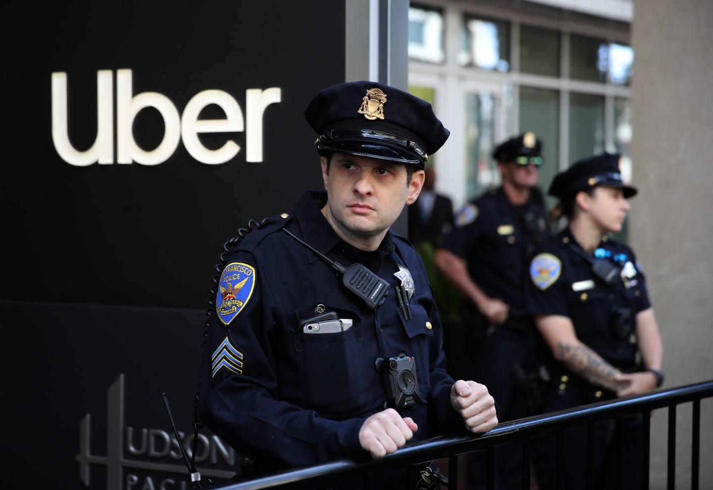 A San Francisco police officer monitors a protest outside of Uber headquarters on August 27, 2019, in San Francisco, Calif. Dozens of Uber and Lyft drivers staged a protest outside of Uber headquarters in support of California assembly Bill 5 and to organize a union for rideshare drivers.