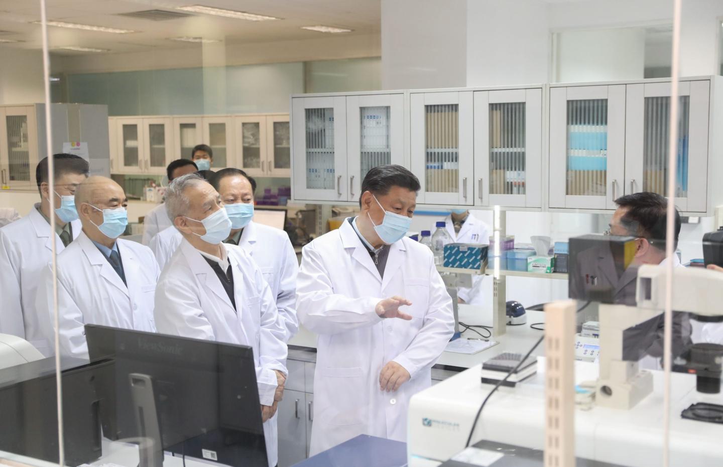Chinese President Xi Jinping learns about progress on COVID-19 vaccine development during his visit to the Academy of Military Medical Sciences in Beijing on March 2, 2020.