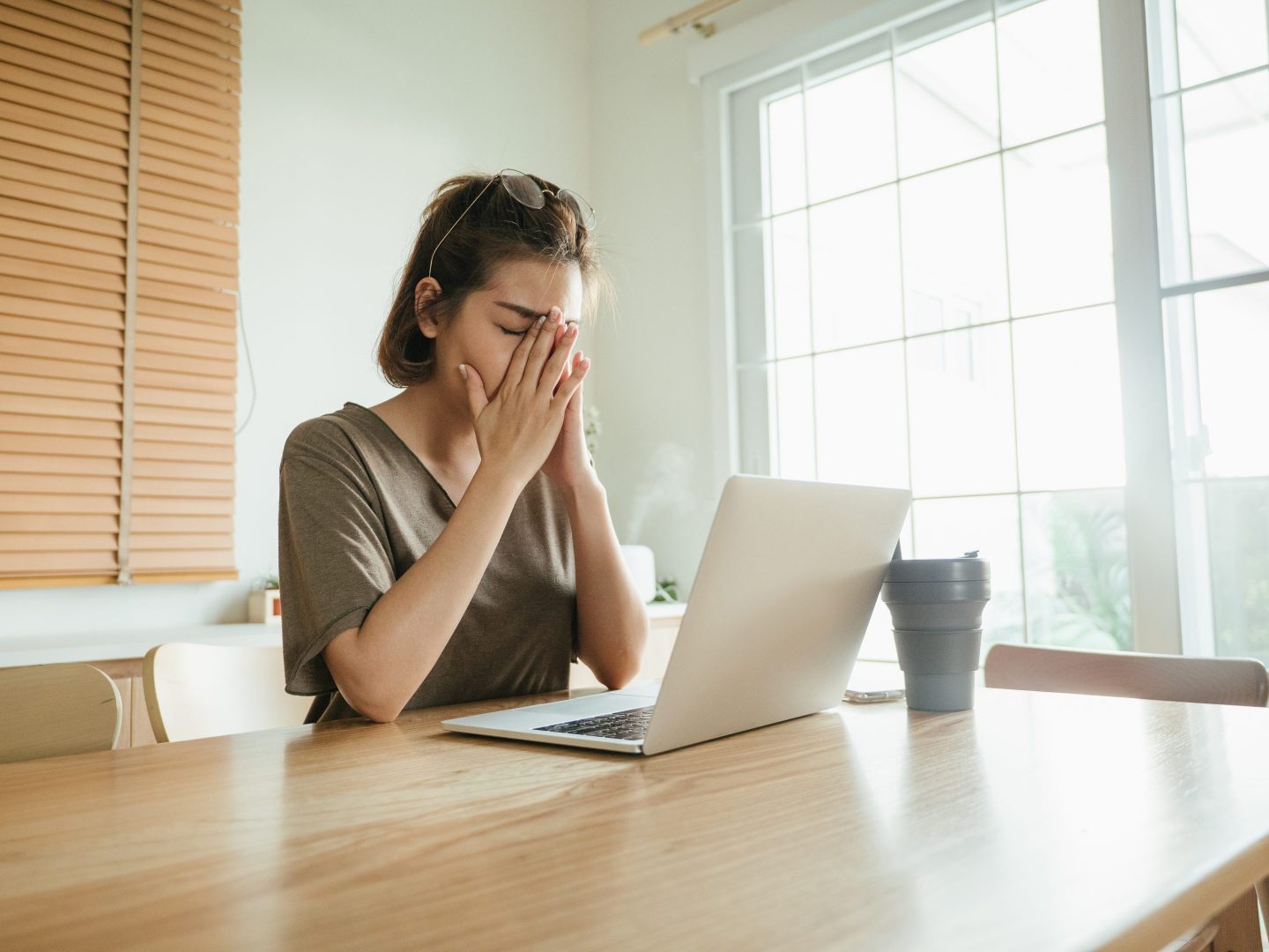 Woman sitting at desk on laptop frustrated