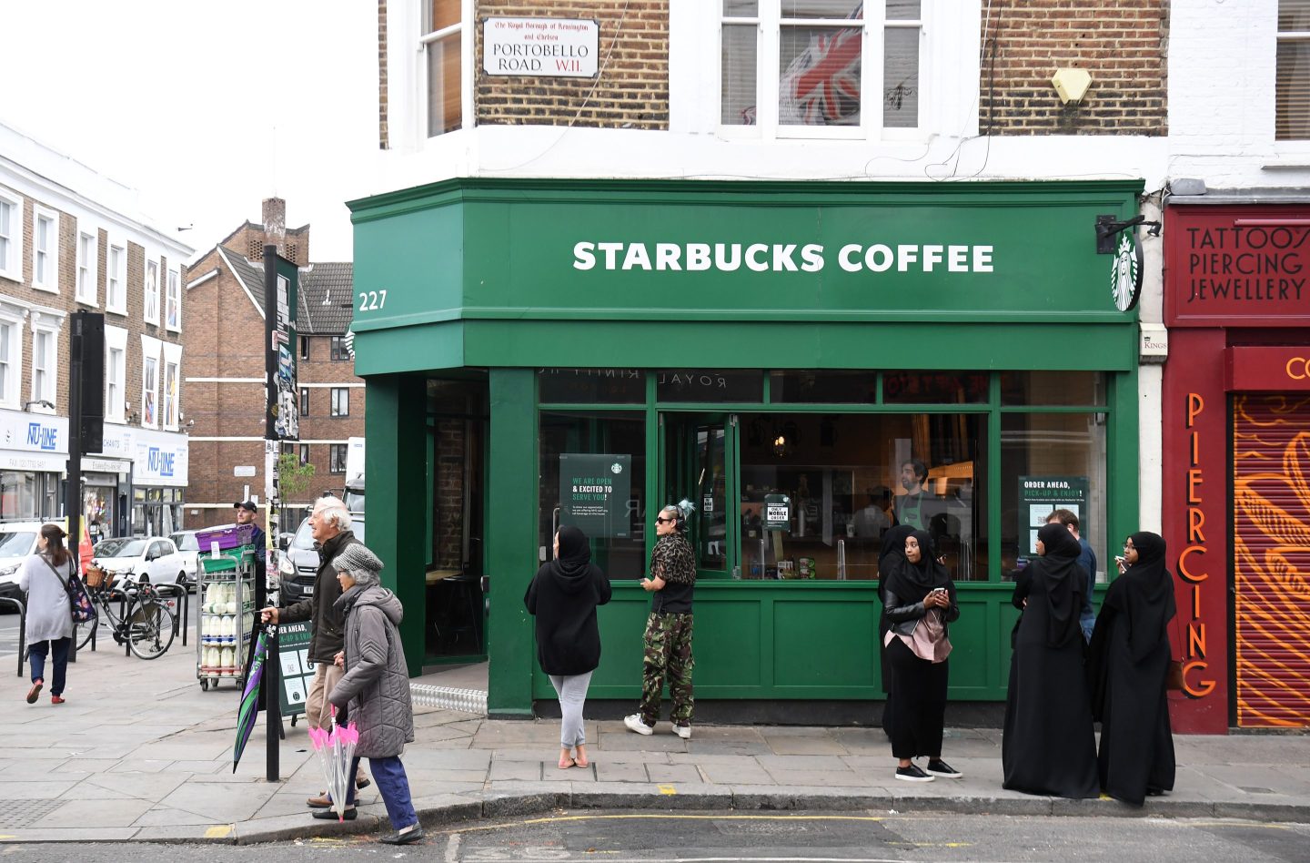 People wait outside Starbucks on Portobello Road in London in 2020, following the introduction of measures to bring England out of lockdown.