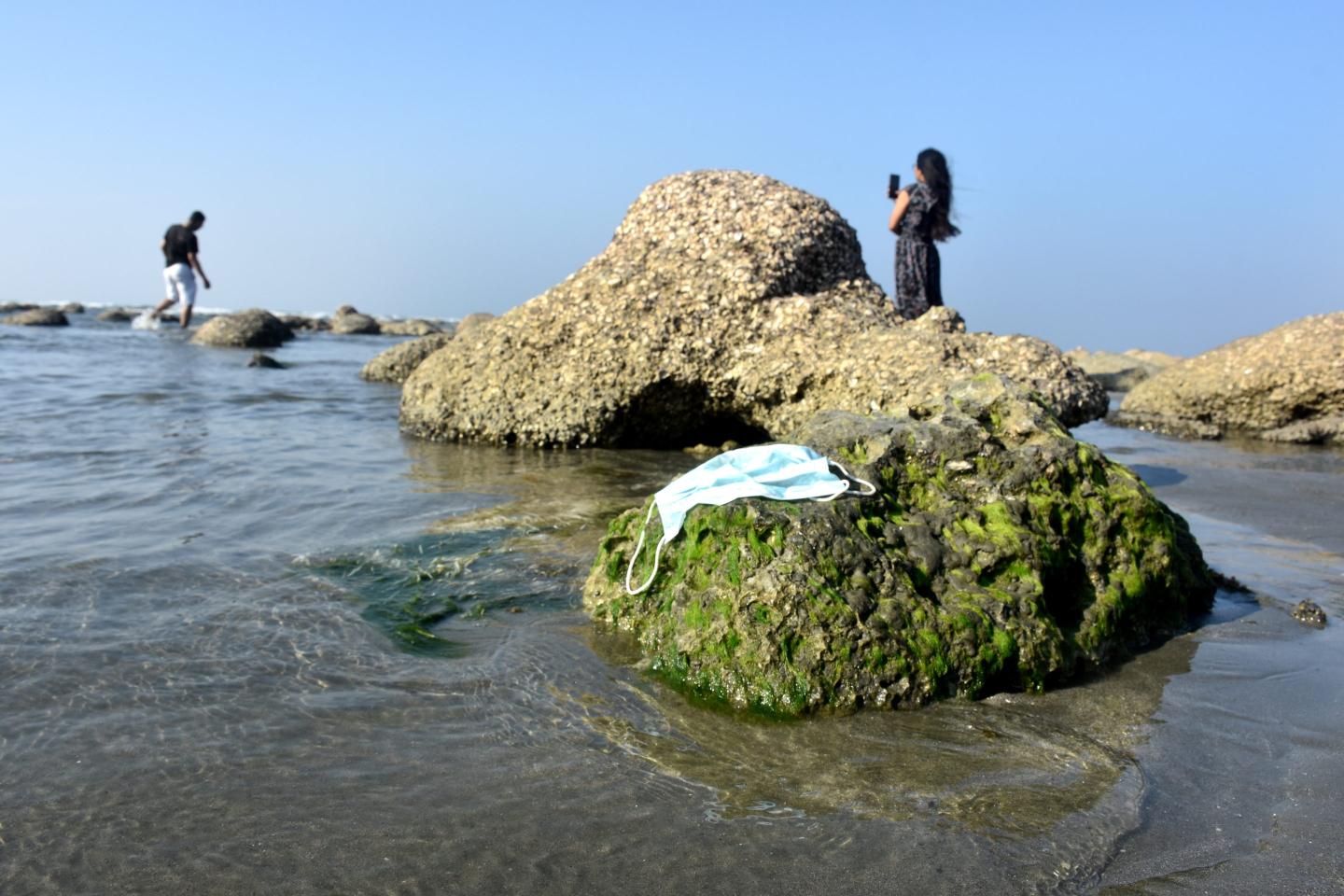 A used mask is seen on beach at marine protected area located in St. Martin's Island, Cox's Bazar, Bangladesh on March 13. Greater COVID transmissibility due to Omicron variants means greater transmissibility in any setting, indoors or outdoors—even if outside is still safer, experts say.