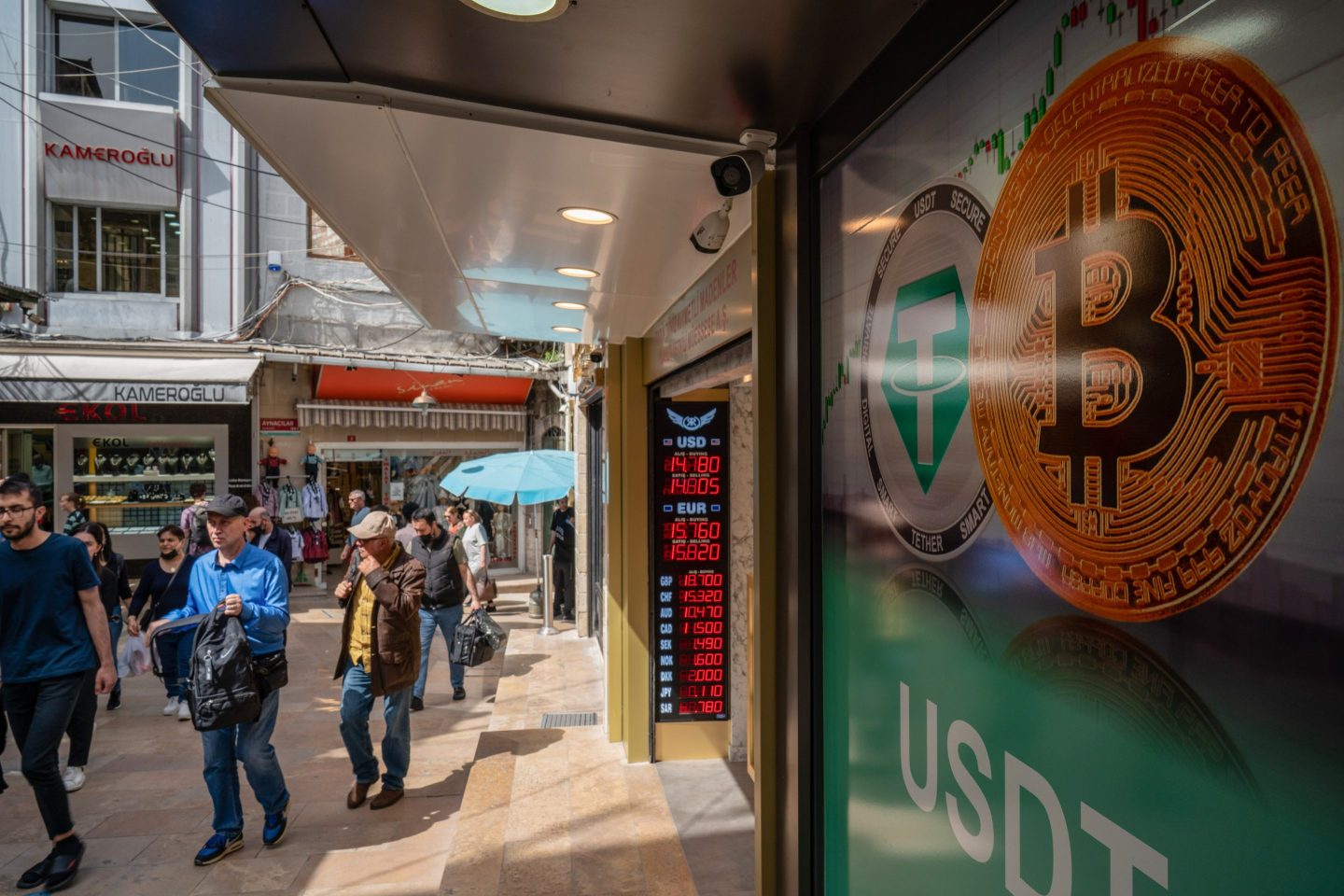 A Tether, left, and Bitcoin logo in the window of a cryptocurrency exchange kiosk in Istanbul, Turkey, on April 26, 2022.