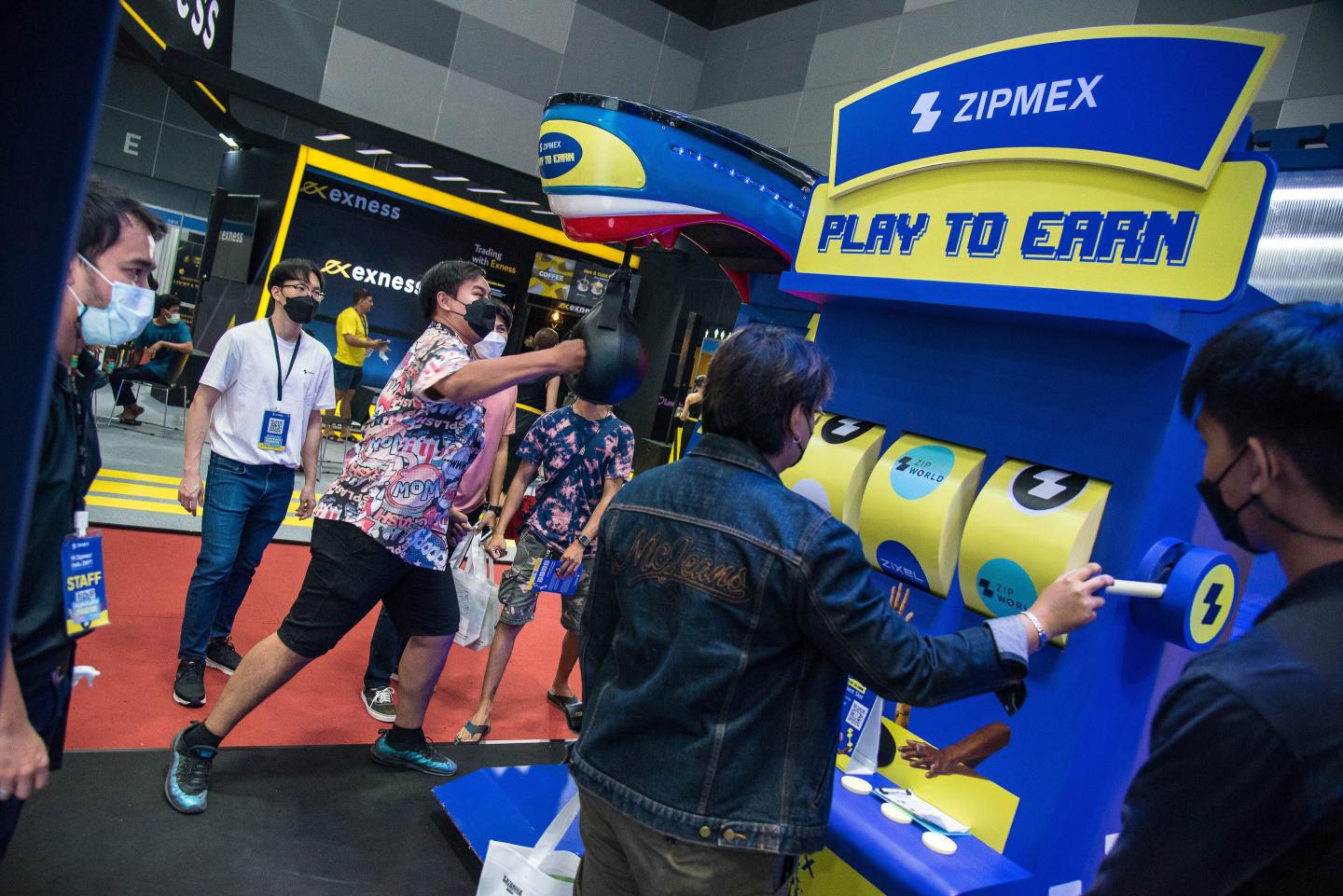 Visitors play games at the Zipmex booth in an effort to win cryptocurrency during Thailand Crypto Expo 2022 at Bangkok International Trade & Exhibition Centre. 