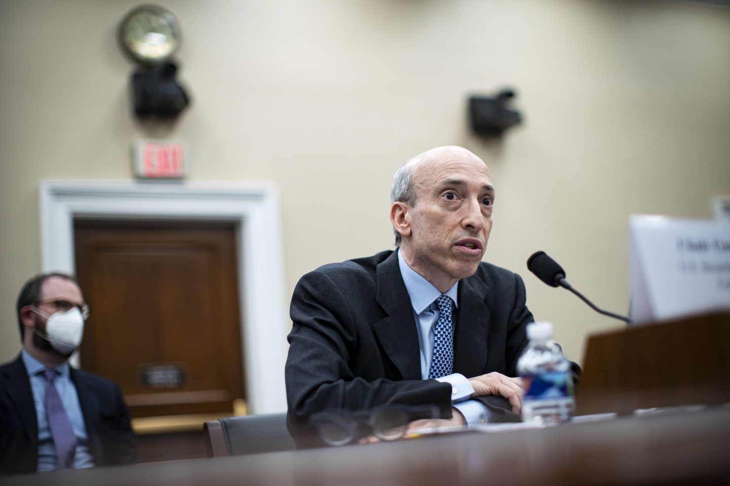 U.S. SEC chairman Gary Gensler sitting while speaking in front of a microphone.