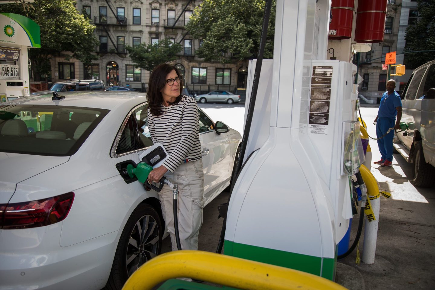 People fuel vehicles at a gas station in the Brooklyn borough of New York