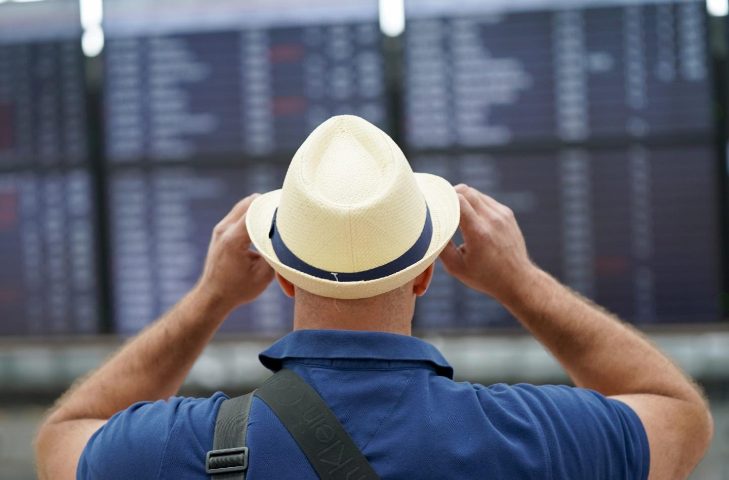 An air traveler stands in front of the check-in counters in Terminal 1 at Hamburg Airport on July 1.