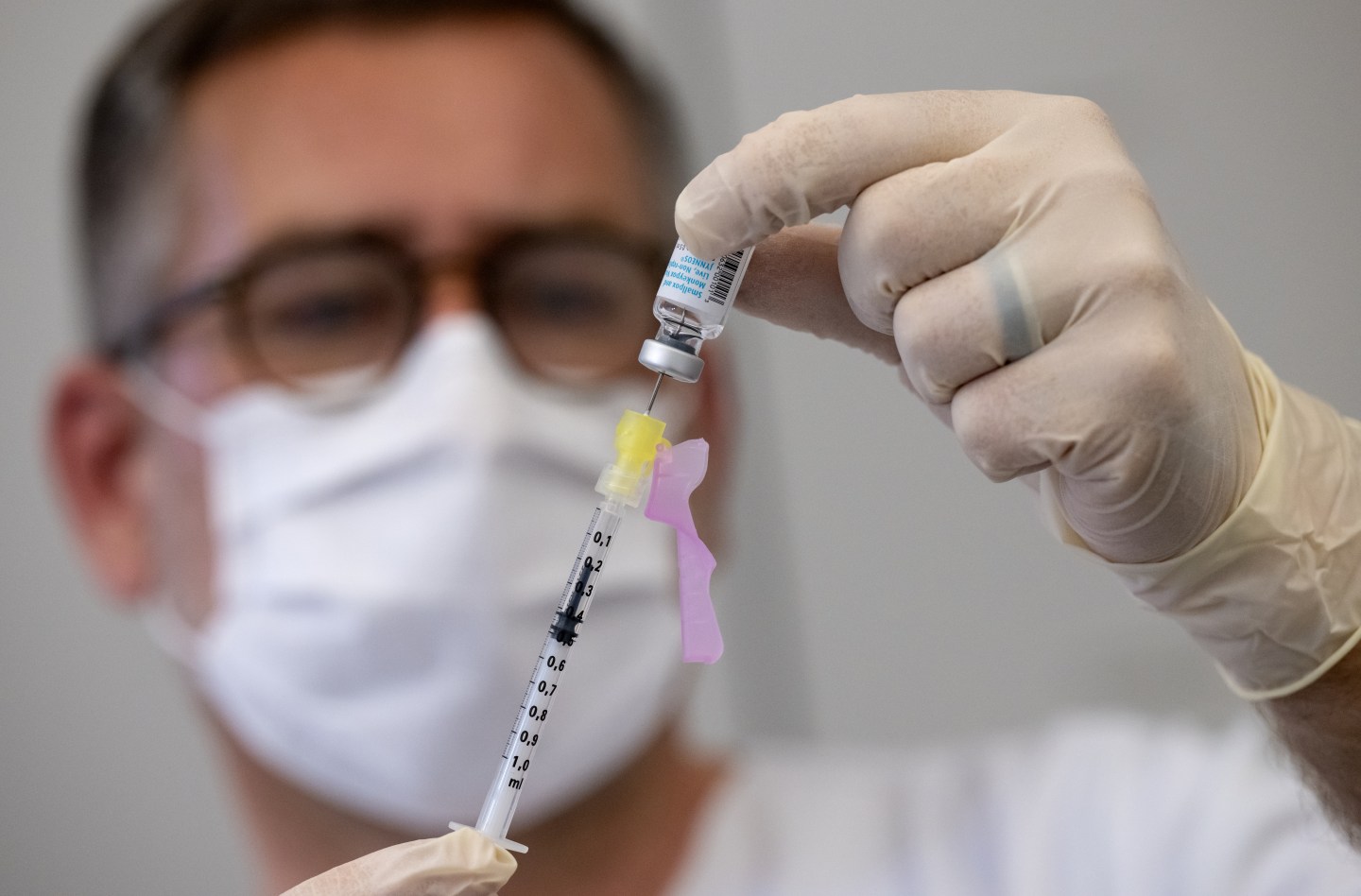 A man holding a syringe of monkeypox vaccine