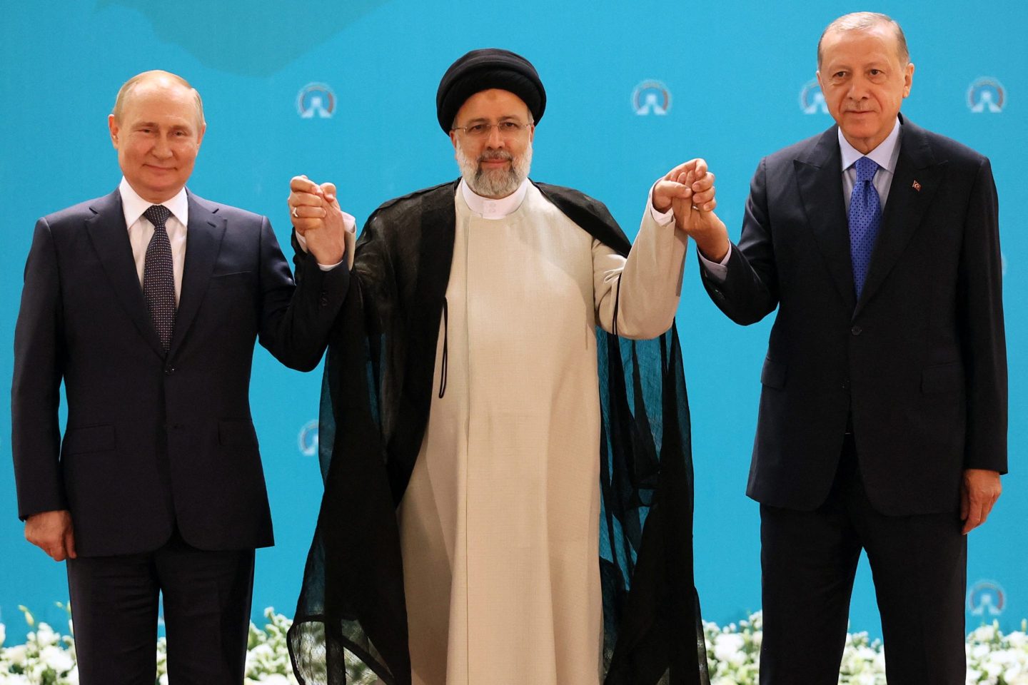 (L-R) Russian President Vladimir Putin, Iranian President Ebrahim Raisi and Turkish President Recep Tayyip Erdogan pose for a photo before a trilateral meeting on Syria in Tehran on July 19, 2022.